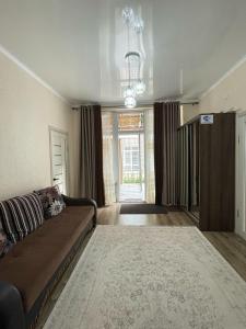 a living room with a couch and a large window at ЦО Париж in Chok-Tal +9 photos