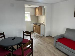 a living room with a couch and a table at Vila FiDa in Gornja Toplica