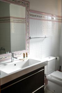 a bathroom with a sink and a mirror and a toilet at 0301 Villa Maracuya in Balcon del Mar +25 photos