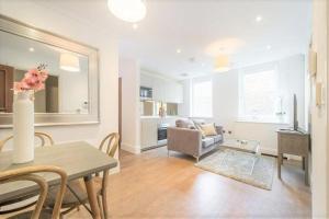a living room with a table and a couch at Luxury flat in Covent Garden in London