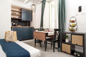 a bedroom with a bed and a desk and a table at Nautilus Suites & Rooms in Olbia