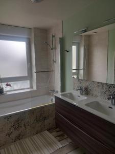 a bathroom with a tub and a sink and a window at Maison Maurice Quimper in Quimper +17 photos