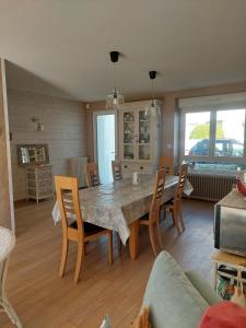 a living room with a dining room table and chairs at Maison Maurice Quimper in Quimper