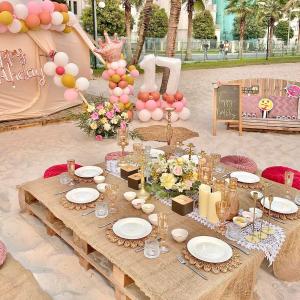 a table with plates and flowers on top of it at Bống Homestay-Luxury Apartment-Vinhomes Grand Park in Long Bình +39 photos