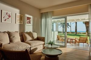 a living room with a couch and a table at Nissi Beach Resort in Ayia Napa