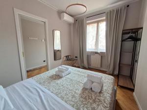 a bedroom with a white bed with towels on it at Best View Boutique Apartments in Bergamo
