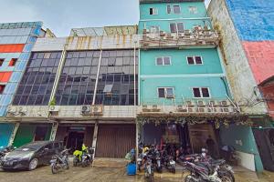 a group of motorcycles parked outside of a building at Guest House 88 RedPartner in Jakarta +7 photos