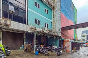 a group of motorcycles parked in front of a building at Guest House 88 RedPartner in Jakarta