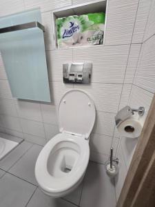 a bathroom with a toilet and a sign on the wall at Domeček Trojanovice in Trojanovice