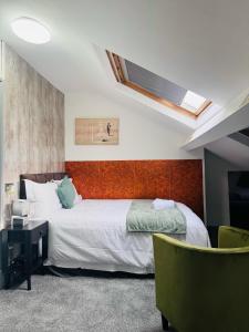 a bedroom with a large bed and a skylight at Apex Rooms Manchester in Manchester