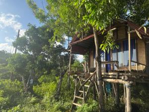 a tree house on the side of a hill at Waterfall Inn Sunset & Nature 