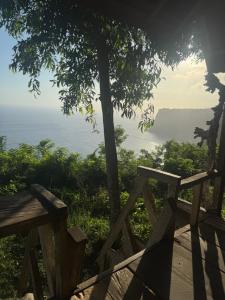 a wooden bench sitting on top of a tree at Waterfall Inn Sunset & Nature  +10 photos