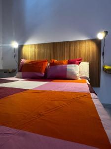 Una cama grande con almohadas de colores en una habitación. en Villa privada con jardín,2 dormitorios, en Playa Blanca 15 fotos más