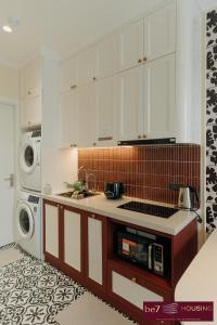 a kitchen with a sink and a dishwasher at Nice&New Attic 1BR Apartment,closely to Parking ares, Seasalt Ocean, Freshwater Ocean of Hanoi city in Vinhomes Ocean Park in Hanoi