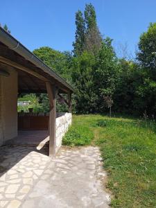 a stone patio with a pavilion in a yard at Duplex indépendant dans Longère in La Croix-en-Touraine +6 photos