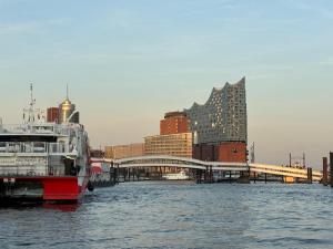 a boat in the water next to a building at yusuite 2 in Hamburg