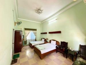 Ένα ή περισσότερα κρεβάτια σε δωμάτιο στο OYO 1297 Hotel Hung Lam