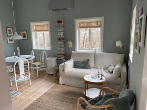 a living room with a couch and a table at Swedish Tiny House 'lyxig lillstuga' in Mollösund