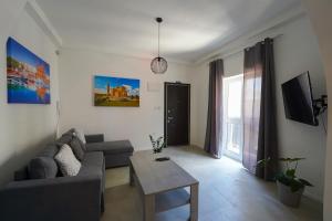 a living room with a couch and a table at Flora Flats 1st, 2nd and 3rd floor appartments no lift in St Paul's Bay