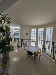a living room with a table and chairs and a plant at Villa Lumineuse in Nyons +11 photos