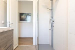 a shower with a glass door in a bathroom at appartamento centralissimo vista terme in Vittorio Veneto