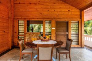 a dining room with a table and chairs at Senaro Farms in Varagampadi