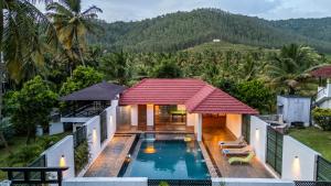 an aerial view of a house with a swimming pool at Senaro Farms in Varagampadi