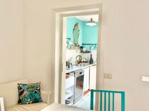 a kitchen with a couch and a table in a room at Casa di Luca in Viareggio
