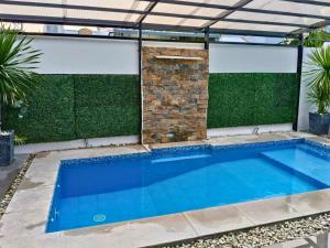 a swimming pool in the middle of a house at YBonita in Sampong