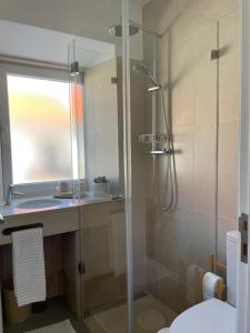 a bathroom with a shower and a toilet and a sink at Casa da Avó in Sesimbra +18 photos