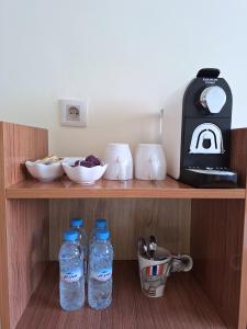 a shelf with two bottles of water and a blender at Cool Family Apartment 2Chambres Balcon,WiFi,Tanger in Tangier