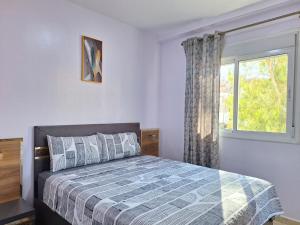 a bedroom with a bed and a window at Cool Family Apartment 2Chambres Balcon,WiFi,Tanger in Tangier +24 photos