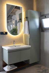 a bathroom with a sink and a mirror at Akkızhan Otel in Karaagac +94 photos