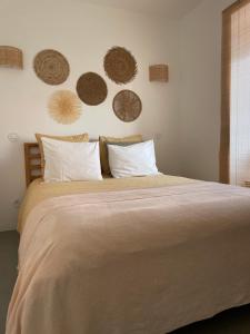 a bedroom with a large bed with many hats on the wall at Casa da Avó in Sesimbra
