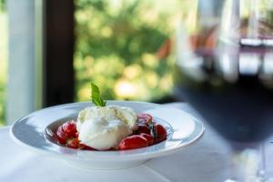 a plate of food with ice cream and fruit on a table at I Cancelli -Mugello Park Family Village in Palazzuolo sul Senio