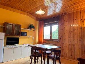 a kitchen with a table and chairs and a window at RESIDENZA VALLE VIGEZZO in Santa Maria Maggiore