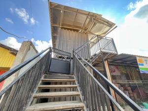 a set of stairs leading up to a building at RedDoorz Syariah at Budget Guesthouse Sepaku in Sepaku