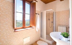 a bathroom with a tub and a sink and a window at Masseria Perugini in San Marco Argentano +27 photos