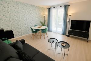 a living room with a couch and a table at Place Toscane, 8P, Fibre et Parking à Disneyland in Serris