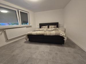 a bedroom with a bed and a tile floor at FeWo Lupi in Stockach