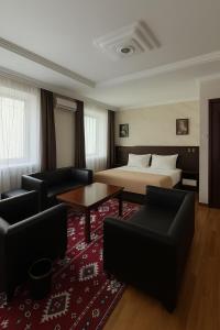 a hotel room with a bed and a red rug at Evergreen Hotel in Ulaanbaatar