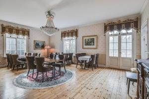 a dining room with a table and chairs at Hotell Plevnagården in Malmköping