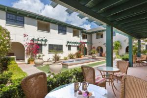 an outdoor patio with tables and chairs and a pool at 1906 Lodge in San Diego