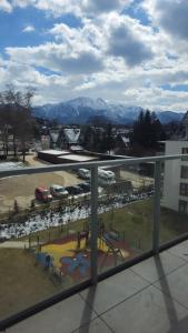 a view of a playground from a window of a building at 408 - Apartament Zakopiański z balkonem - Sauna & Jacuzzi & Plac zabaw & Siłownia in Zakopane