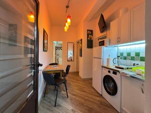 a small kitchen with a table and a refrigerator at Apartments Montevibe in Tivat