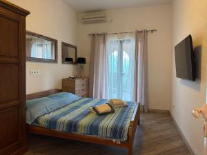 a bedroom with a bed with a tv and a window at Apartments Montevibe in Tivat +12 photos