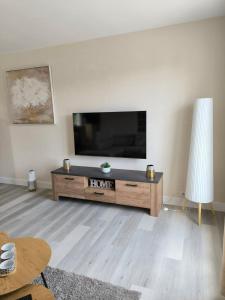 a living room with a flat screen tv on a wall at la maison de Gaston in Rix +2 photos