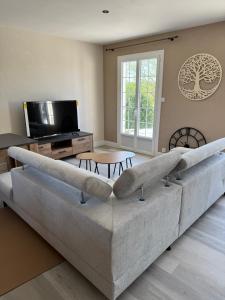 a living room with a large couch and a table at la maison de Gaston in Rix