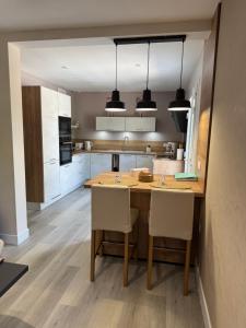 a kitchen with a wooden table and chairs at la maison de Gaston in Rix