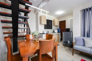 a dining room and kitchen with a table and chairs at Furnished 3BR Townhouse Near Cebu IT Park with Parking, Fast WiFi, Netflix and More in Cebu City +42 photos
